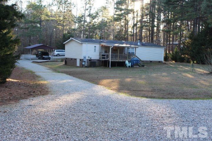 141 Waters Edge Road Henderson, NC 27537 - Photo 26 of 30 a view of a backyard with large trees and wooden fence