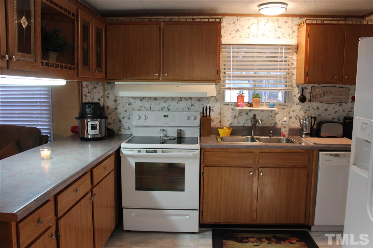 141 Waters Edge Road Henderson, NC 27537 - Photo 4 of 30 a kitchen with a stove and a white cabinets