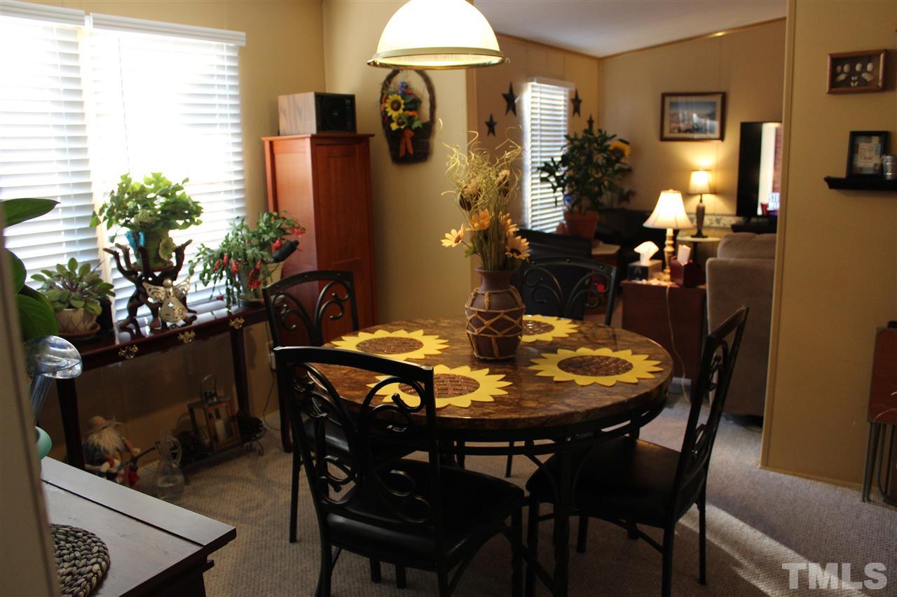 141 Waters Edge Road Henderson, NC 27537 - Photo 6 of 30 a view of a dining room with furniture and wooden floor