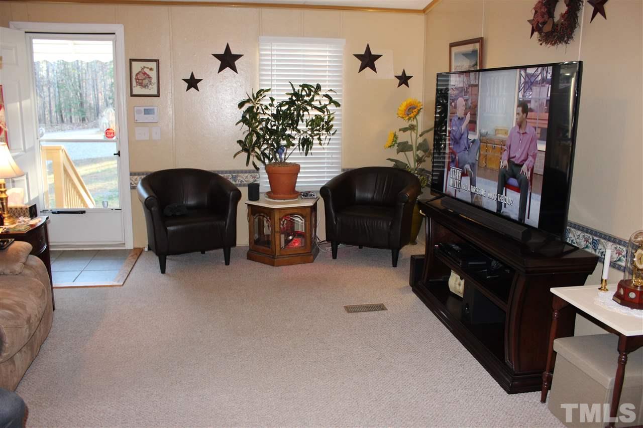 141 Waters Edge Road Henderson, NC 27537 - Photo 7 of 30 a living room with furniture and a flat screen tv