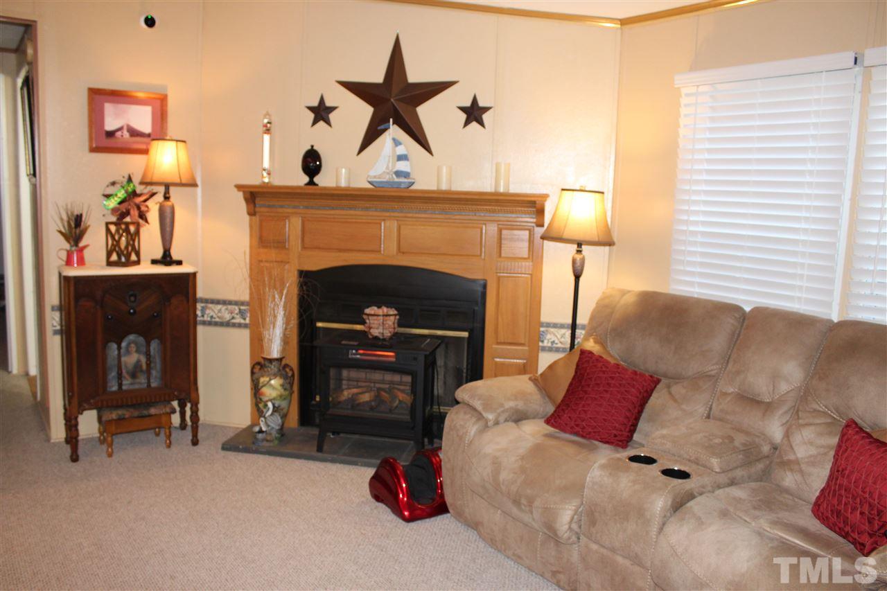 141 Waters Edge Road Henderson, NC 27537 - Photo 8 of 30 a living room with furniture and a fireplace