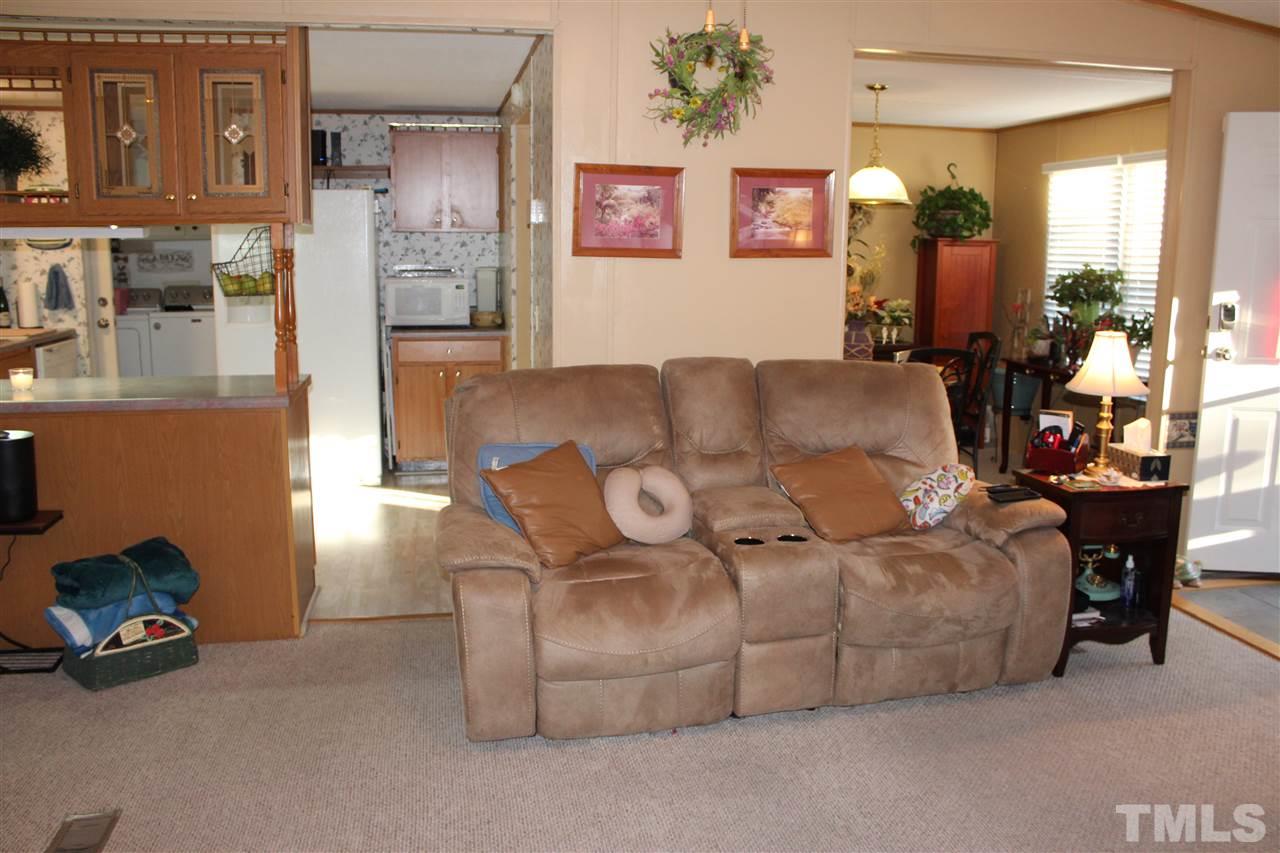141 Waters Edge Road Henderson, NC 27537 - Photo 9 of 30 a living room with furniture and a chandelier