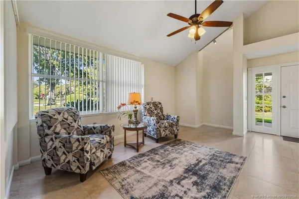 a living room with furniture and a large window