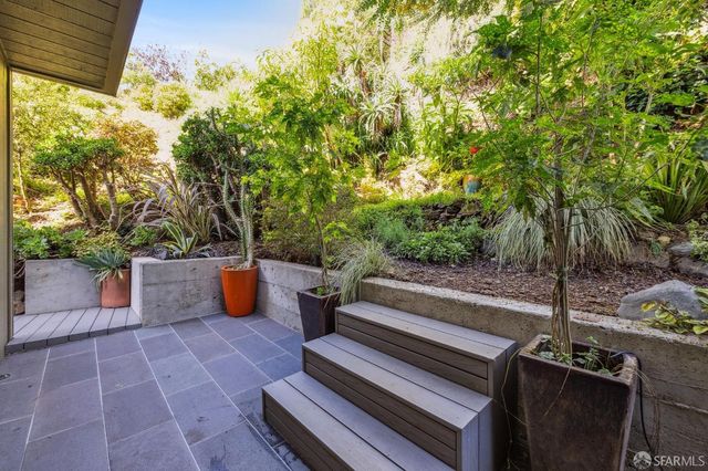 a view of balcony with furniture and trees
