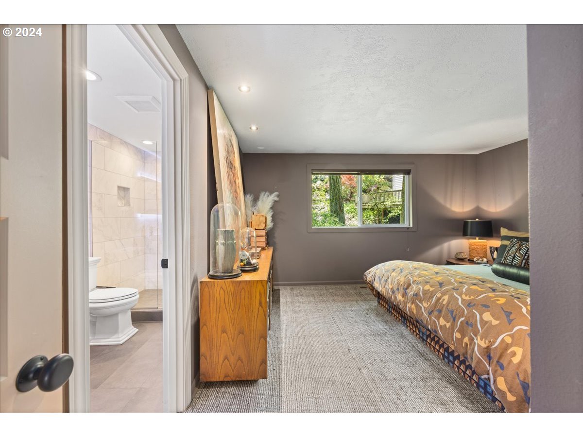 4432 Northwest Barnes Road Portland, OR 97210 - Photo 20 of 36 a bedroom with a bed and a window