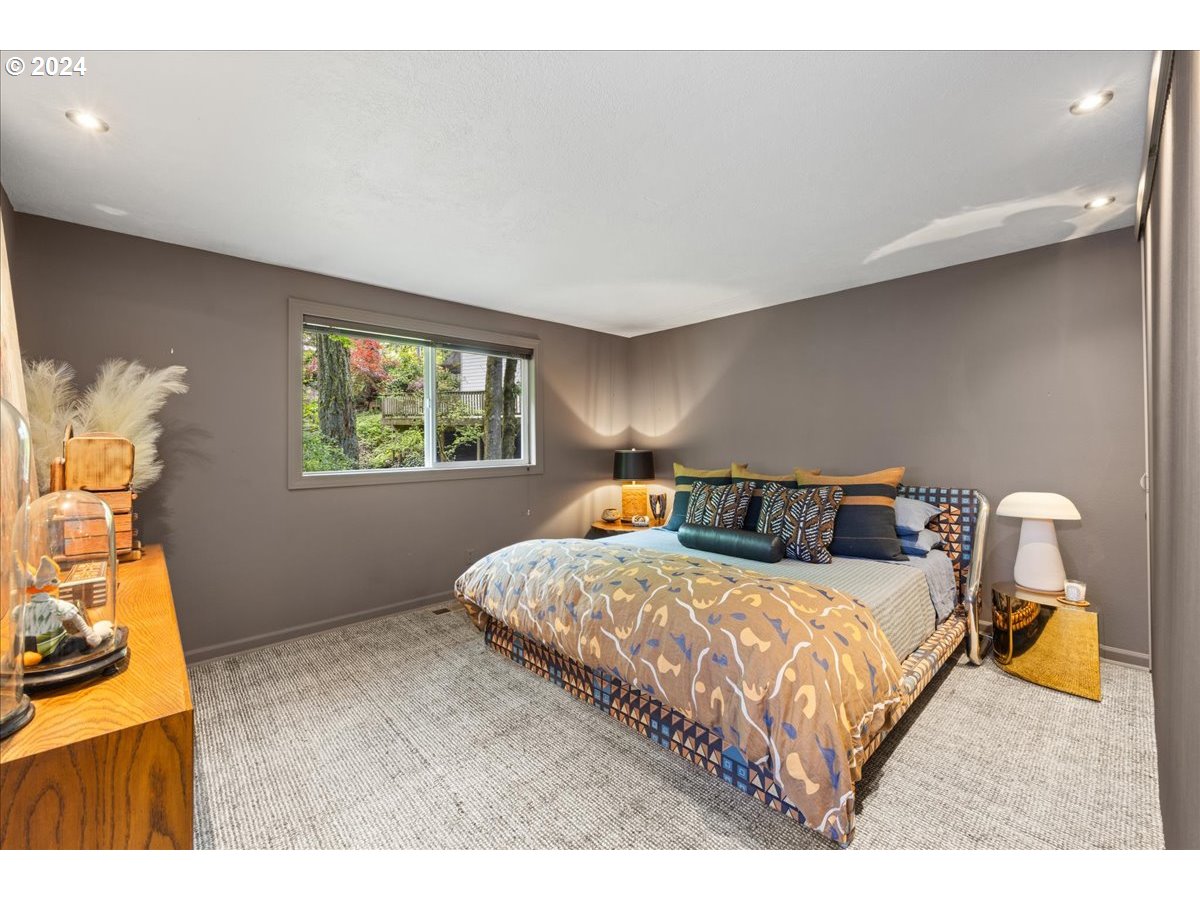 4432 Northwest Barnes Road Portland, OR 97210 - Photo 21 of 36 a bedroom with a bed and window