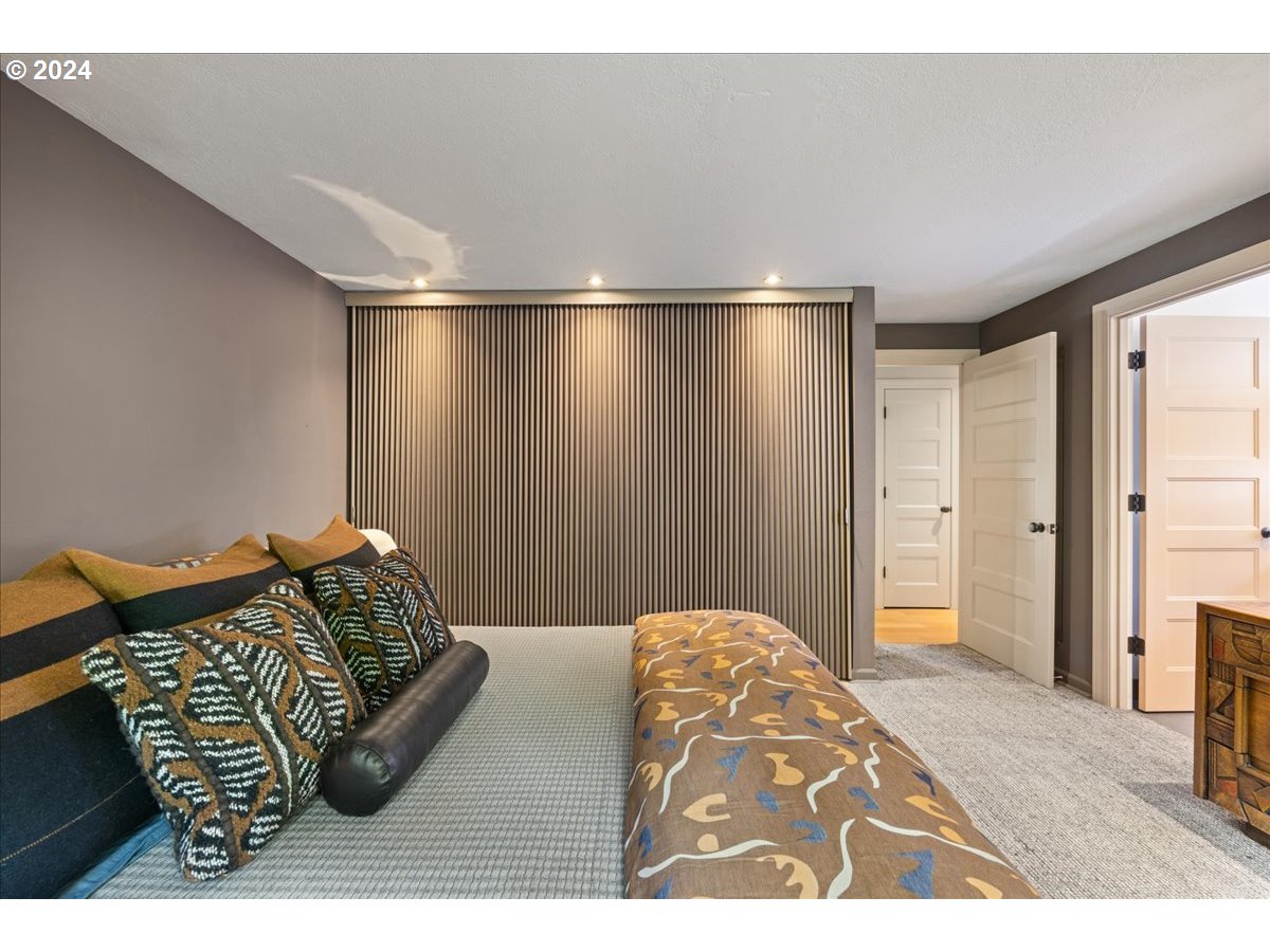 4432 Northwest Barnes Road Portland, OR 97210 - Photo 22 of 36 a view of a bedroom with furniture and wooden floor