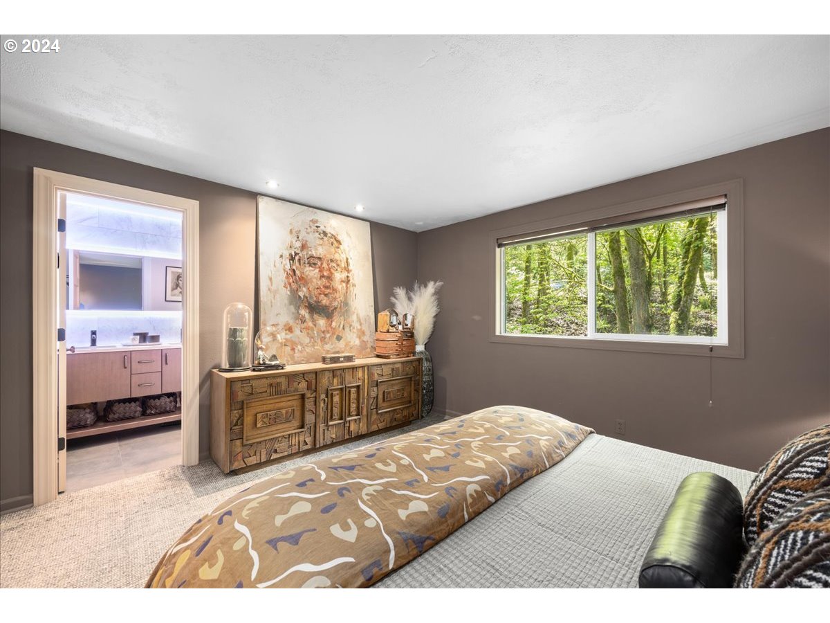 4432 Northwest Barnes Road Portland, OR 97210 - Photo 23 of 36 a bedroom with a large bed and a window