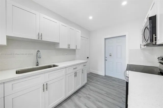 a kitchen with a sink and cabinets
