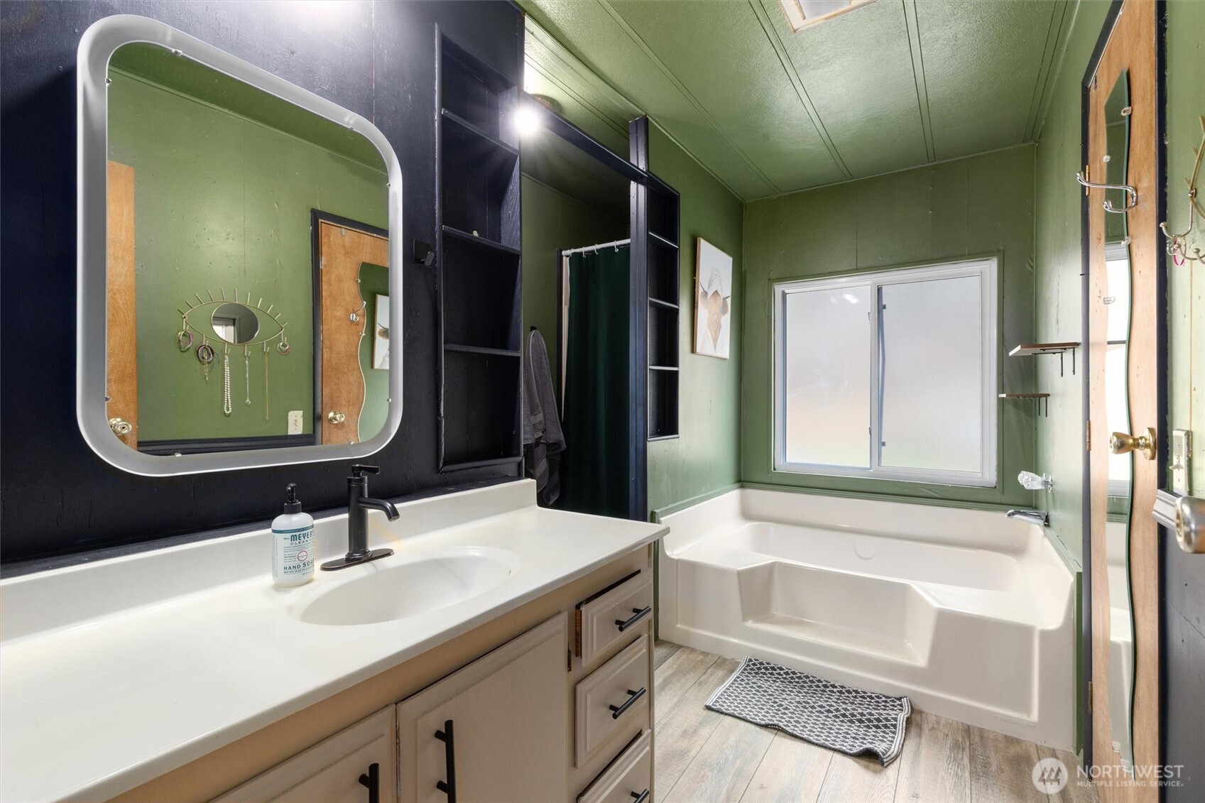 14601 Jim Creek Road Arlington, WA 98223 - Photo 16 of 35 a bathroom with a bathtub sink and mirror
