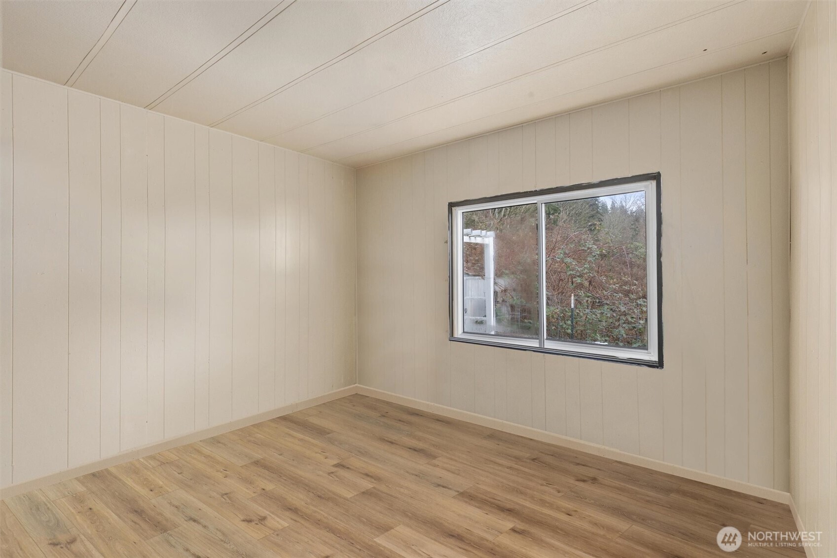 14601 Jim Creek Road Arlington, WA 98223 - Photo 19 of 35 a view of an empty room with wooden floor and a window