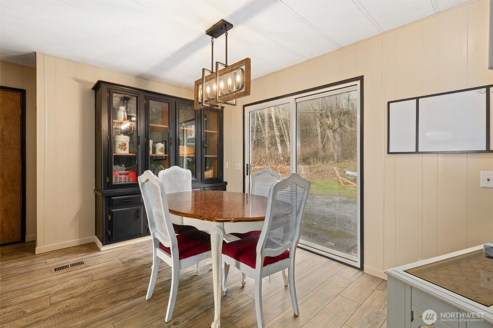 14601 Jim Creek Road Arlington, WA 98223 - Photo 10 of 35 a dining room with furniture a chandelier and wooden floor