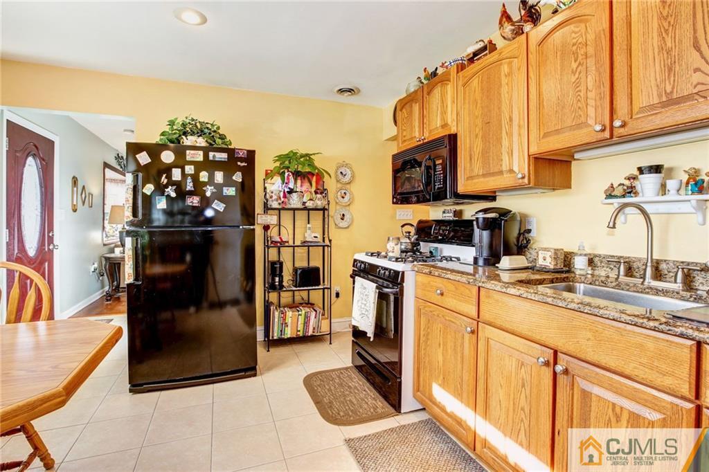 156 Winthrop Road Edison, NJ 08817 - Photo 2 of 28 a kitchen with a sink microwave and refrigerator