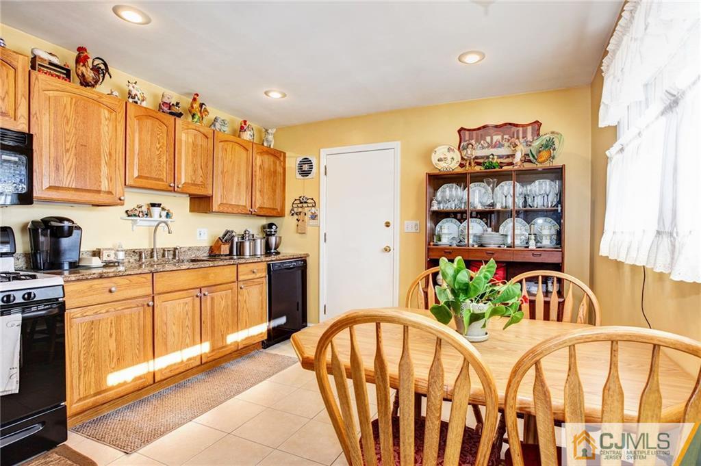 156 Winthrop Road Edison, NJ 08817 - Photo 19 of 28 a kitchen with stainless steel appliances kitchen island granite countertop a refrigerator a stove top oven a sink and dishwasher