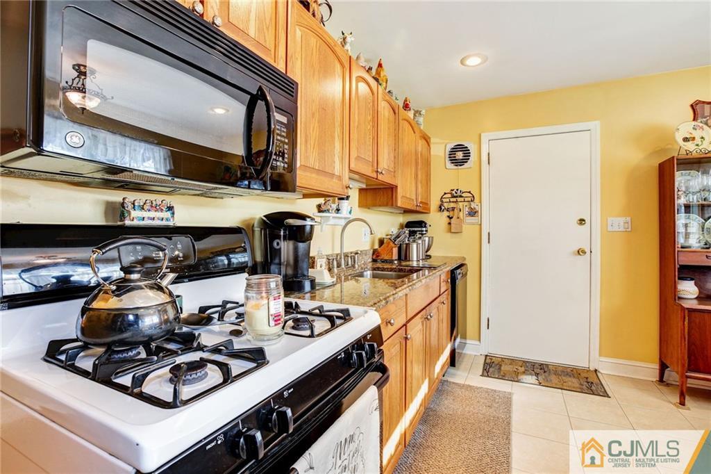 156 Winthrop Road Edison, NJ 08817 - Photo 20 of 28 a kitchen with a stove and a refrigerator