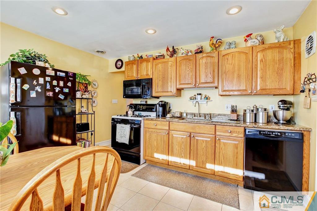 156 Winthrop Road Edison, NJ 08817 - Photo 3 of 28 a kitchen with stainless steel appliances a stove a sink cabinets and a refrigerator