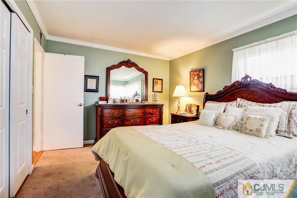 156 Winthrop Road Edison, NJ 08817 - Photo 21 of 28 a bedroom with a bed and a dresser