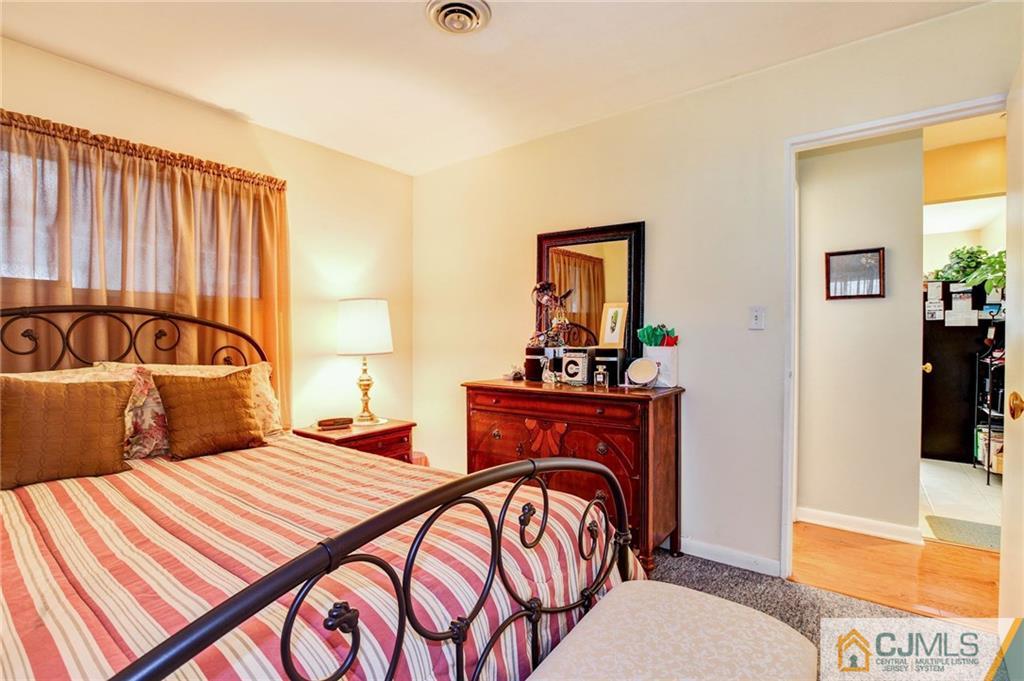 156 Winthrop Road Edison, NJ 08817 - Photo 6 of 28 a bedroom with a bed and wooden floor