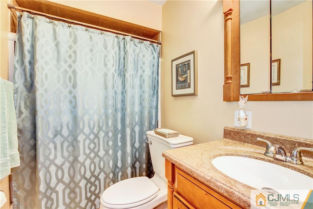 156 Winthrop Road Edison, NJ 08817 - Photo 7 of 28 a bathroom with a granite countertop toilet sink and mirror