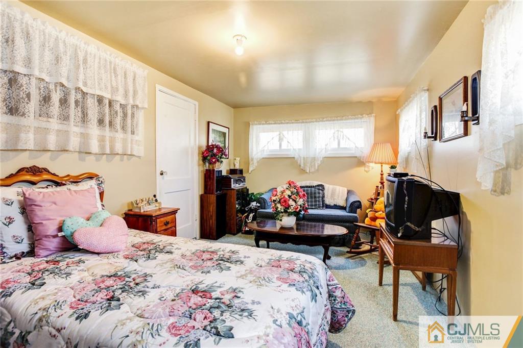 156 Winthrop Road Edison, NJ 08817 - Photo 8 of 28 a bedroom with bed and large windows
