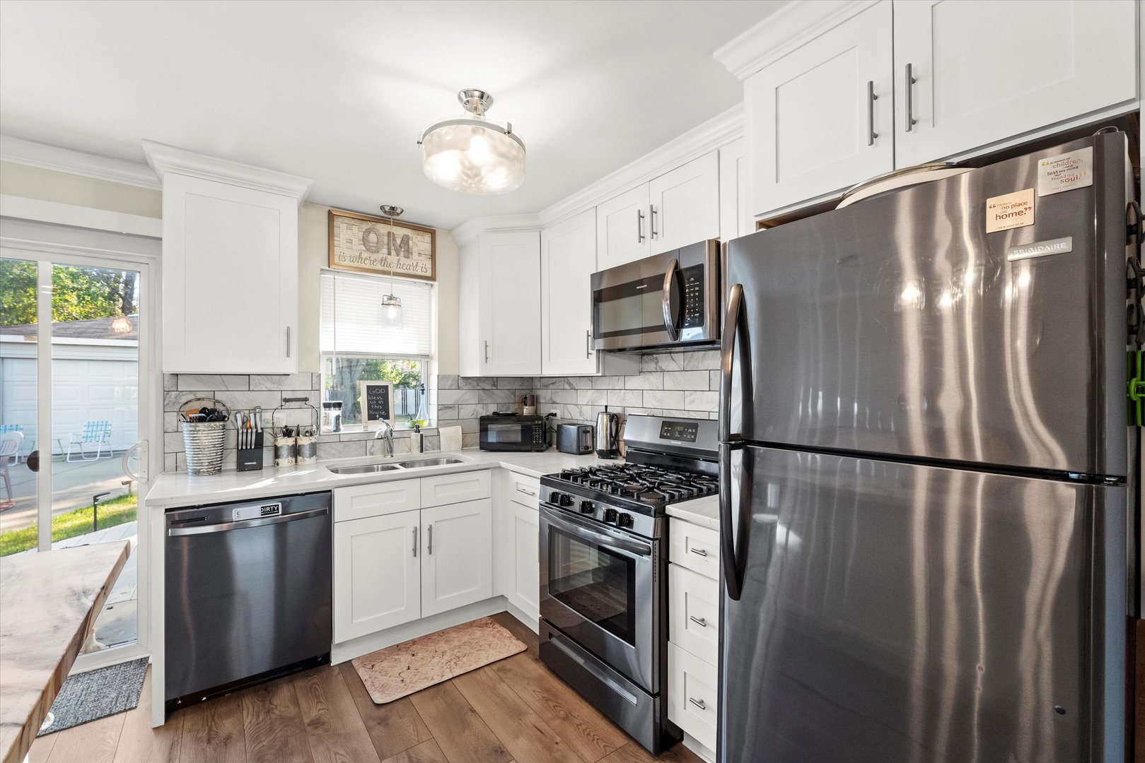 7749 South Octavia Avenue Bridgeview, IL 60455 - Photo 12 of 35 a kitchen with stainless steel appliances a refrigerator sink and cabinets
