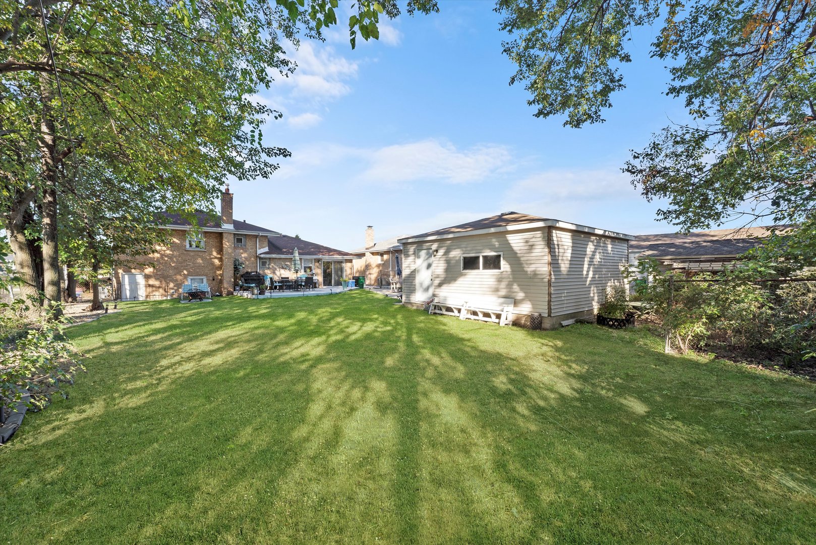 7749 South Octavia Avenue Bridgeview, IL 60455 - Photo 30 of 35 a view of a house with a big yard and large trees