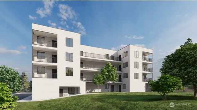 a front view of a building with a garden