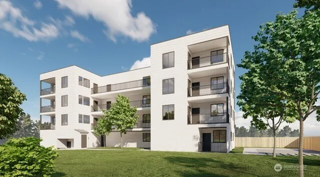 a view of white building with a yard