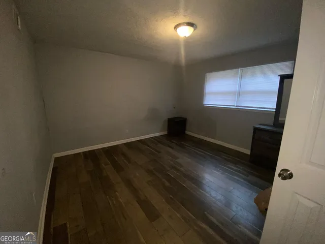 a view of wooden floor and windows in a room