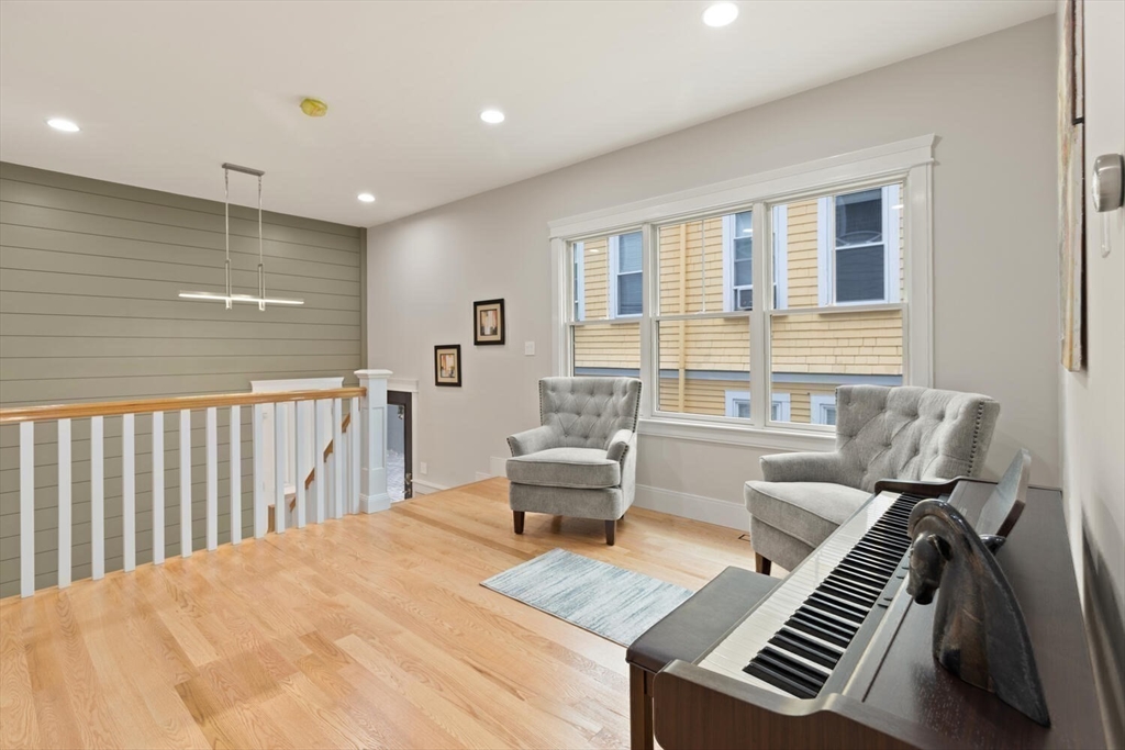 7 Whitman Street, Unit 1 Somerville, MA 02144 - Photo 18 of 35 a living room with furniture and a piano