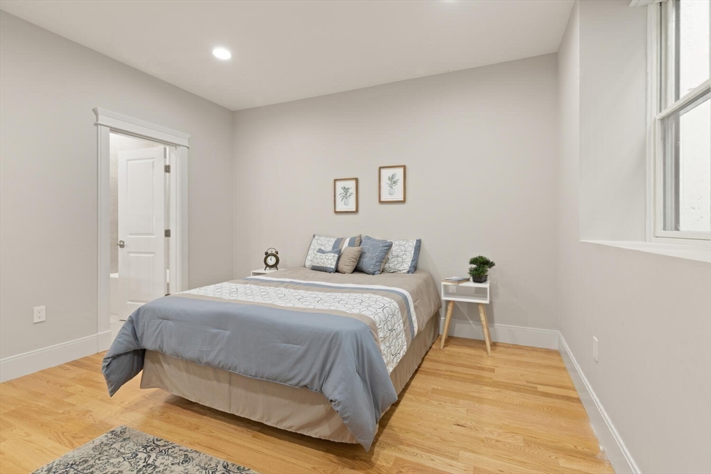 7 Whitman Street, Unit 1 Somerville, MA 02144 - Photo 19 of 35 a bedroom with a bed and a window
