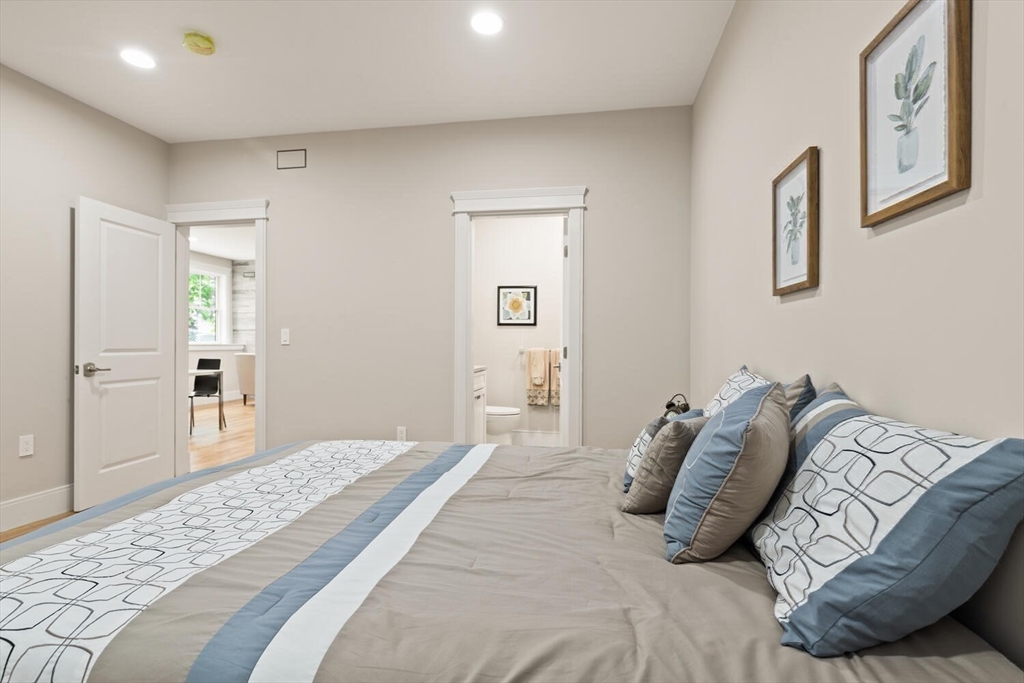 7 Whitman Street, Unit 1 Somerville, MA 02144 - Photo 20 of 35 a bedroom with a bed and painting on the wall