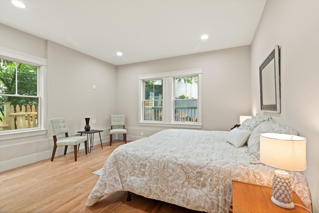7 Whitman Street, Unit 1 Somerville, MA 02144 - Photo 21 of 35 a bedroom with a bed and wooden floor