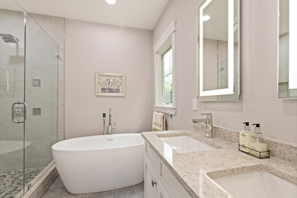 7 Whitman Street, Unit 1 Somerville, MA 02144 - Photo 23 of 35 a bathroom with a tub sink and mirror