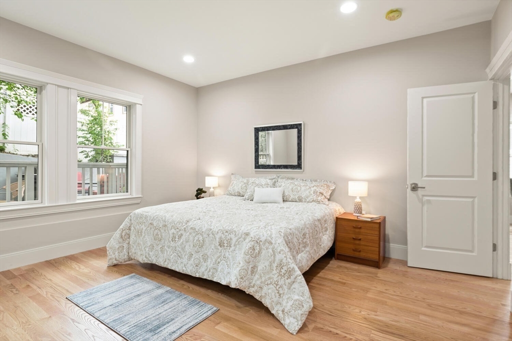 7 Whitman Street, Unit 1 Somerville, MA 02144 - Photo 25 of 35 a bedroom with a bed and a large window