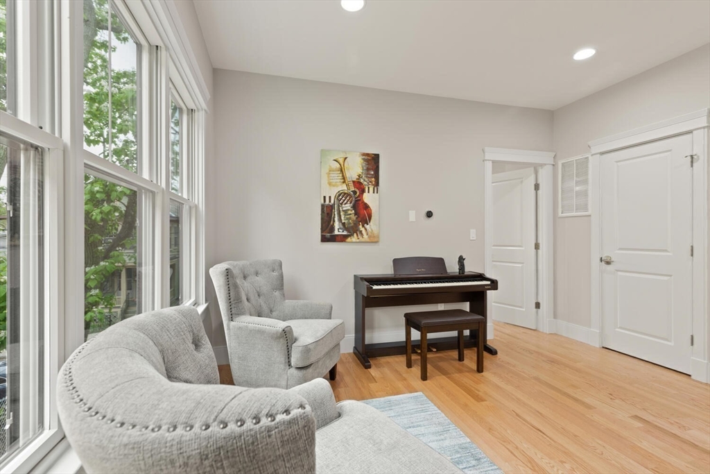 7 Whitman Street, Unit 1 Somerville, MA 02144 - Photo 27 of 35 a living room with furniture and a piano