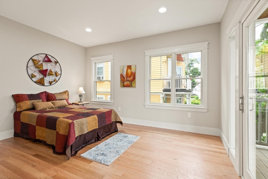 7 Whitman Street, Unit 1 Somerville, MA 02144 - Photo 28 of 35 a bedroom with a bed and a large window