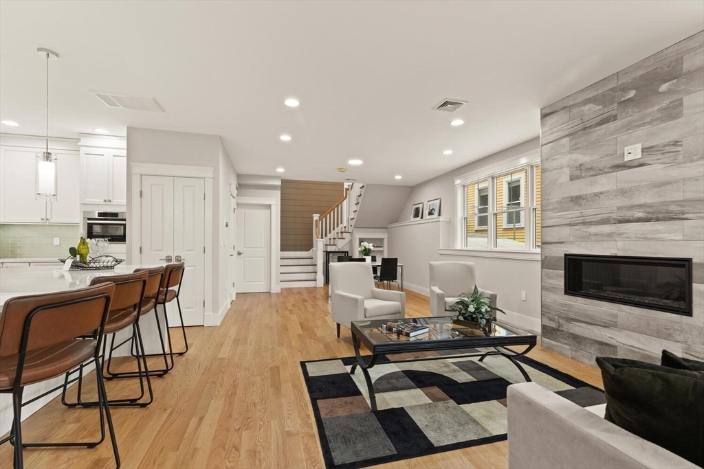 7 Whitman Street, Unit 1 Somerville, MA 02144 - Photo 3 of 35 a living room with furniture and a fireplace