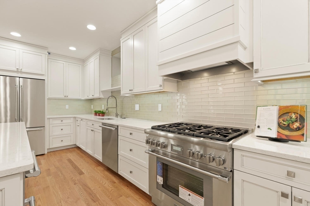 7 Whitman Street, Unit 1 Somerville, MA 02144 - Photo 4 of 35 a kitchen with a stove a sink and a refrigerator