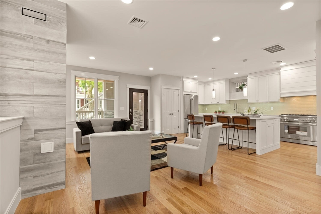 7 Whitman Street, Unit 1 Somerville, MA 02144 - Photo 6 of 35 a living room with stainless steel appliances furniture a dining table and kitchen view