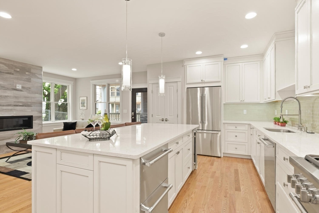 7 Whitman Street, Unit 1 Somerville, MA 02144 - Photo 7 of 35 a kitchen with a sink stove and refrigerator