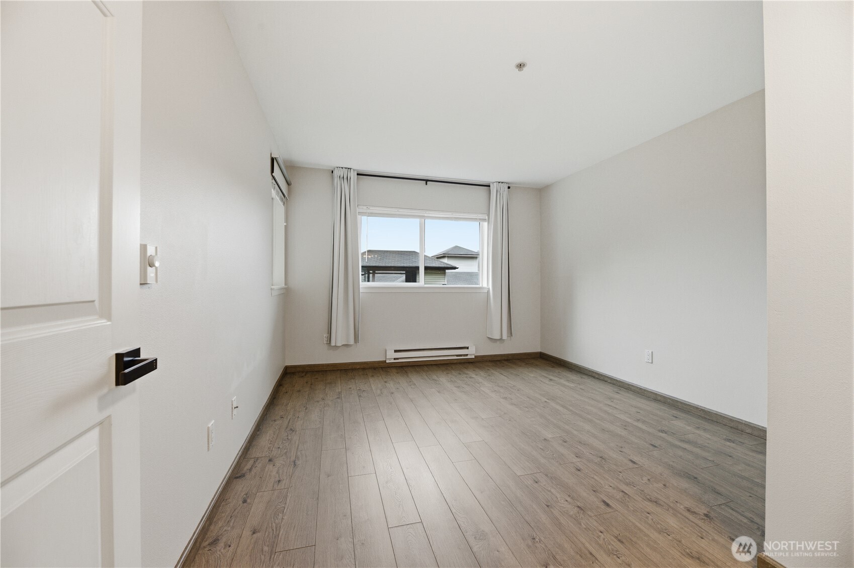 15340 Macadam Road South, Unit B206 Tukwila, WA 98188 - Photo 20 of 29 a view of a room with wooden floor and white walls