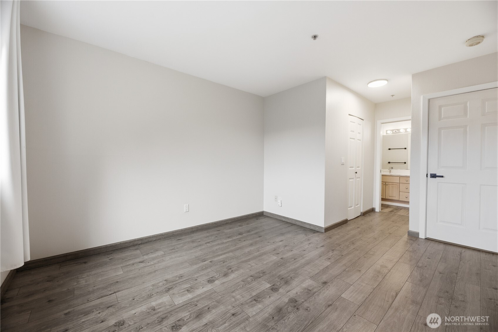 15340 Macadam Road South, Unit B206 Tukwila, WA 98188 - Photo 21 of 29 a view of an empty room with wooden floor and closet
