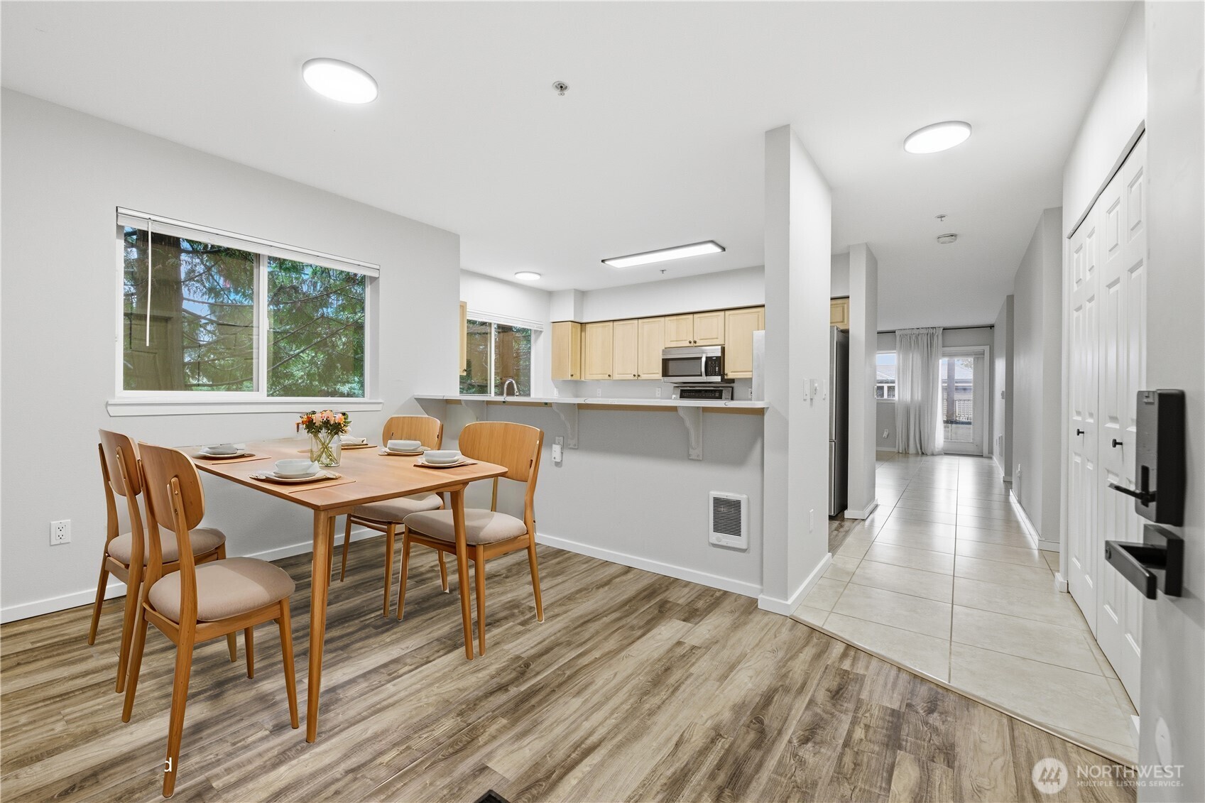 15340 Macadam Road South, Unit B206 Tukwila, WA 98188 - Photo 5 of 29 a view of a dining room with furniture and wooden floor