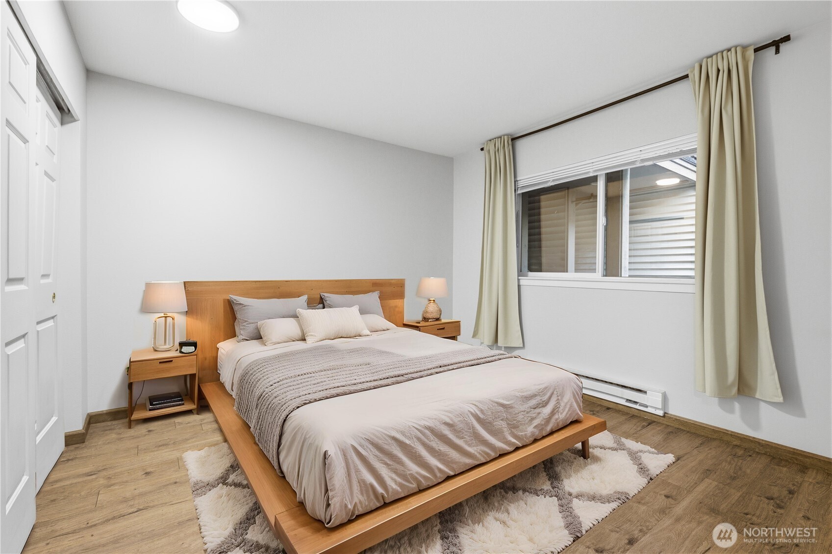 15340 Macadam Road South, Unit B206 Tukwila, WA 98188 - Photo 7 of 29 a bedroom with a bed and wooden floor