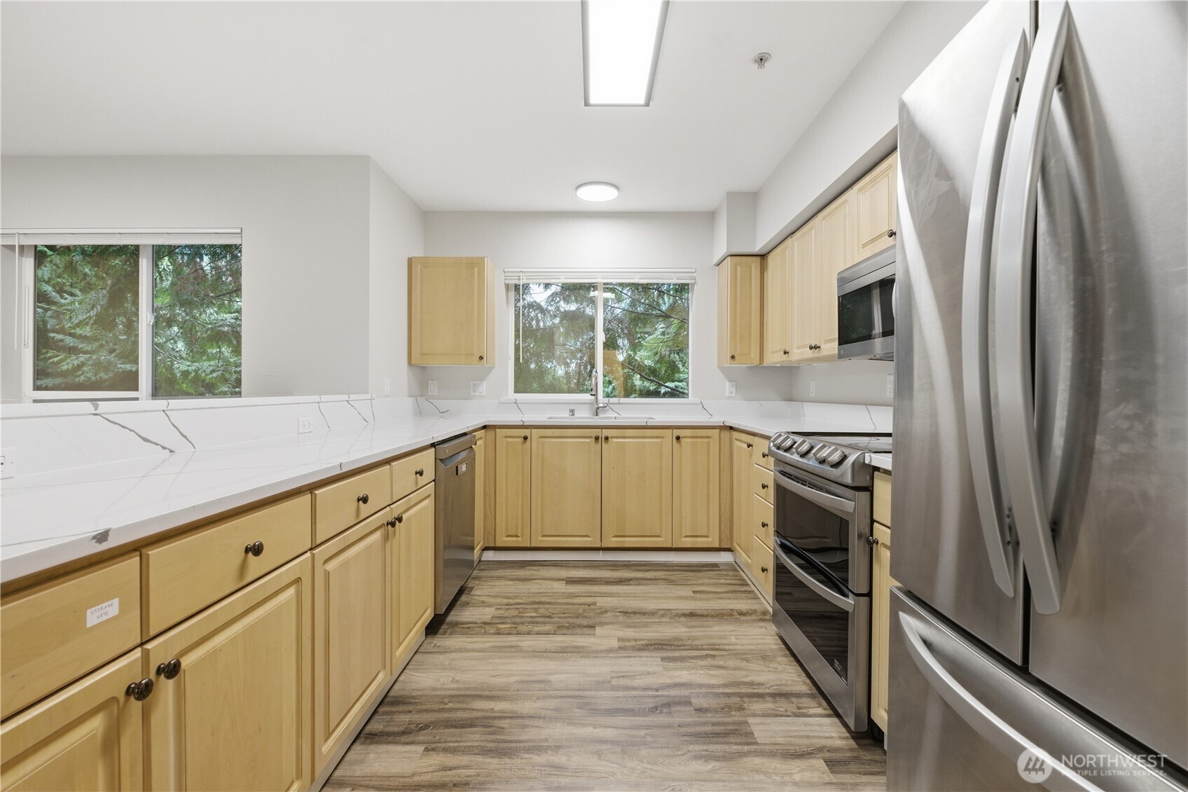 15340 Macadam Road South, Unit B206 Tukwila, WA 98188 - Photo 9 of 29 a kitchen with granite countertop a refrigerator and a sink