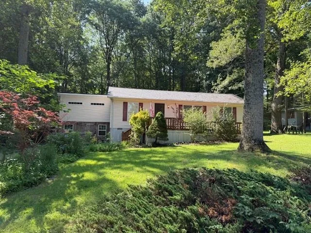 a view of a house with a yard and a patio