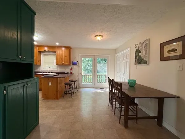 a view of a dining room with furniture and window
