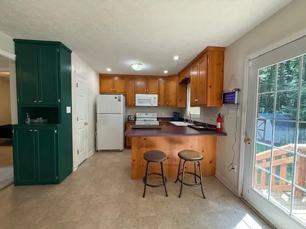 a kitchen with stainless steel appliances granite countertop a refrigerator and a stove