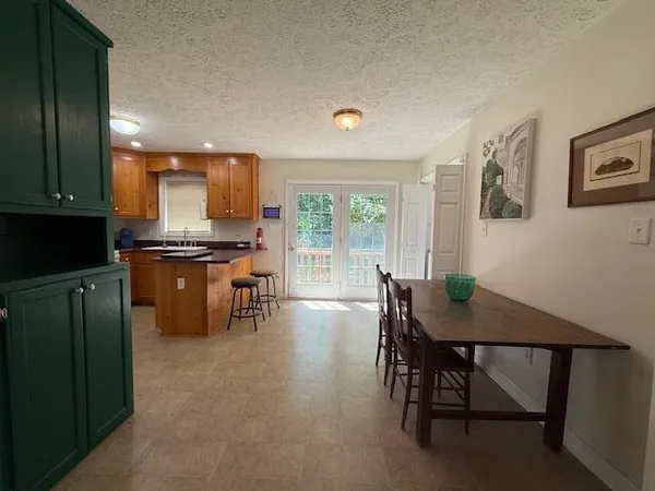 a view of a dining room with furniture and a window